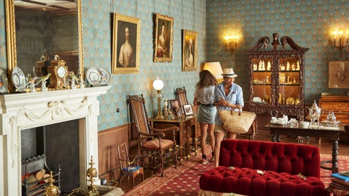 Two visitors walking through the very ornate West Drawing Room at Oxburgh Hall, Norfolk